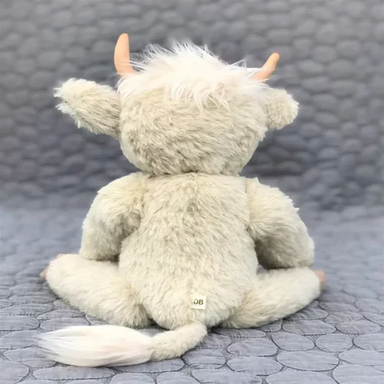 Adorable handmade Scottish Highland Cow stuffed animal with shaggy alpaca fur. Unique & cuddly companion toy.