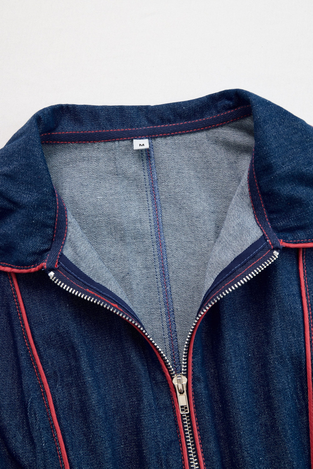 Stylish dark blue wide leg jumpsuit for women with long sleeves and a modern zip front. Fashionable apparel.