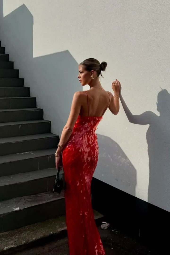 Elegant women's red sequin mermaid prom dress with a deep V-neck and open back design.