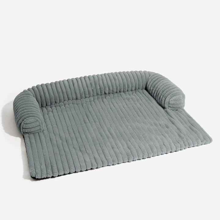 Washable fluffy pet sofa cover, acting as a stylish furniture protector & cozy dog bed for any home decor.