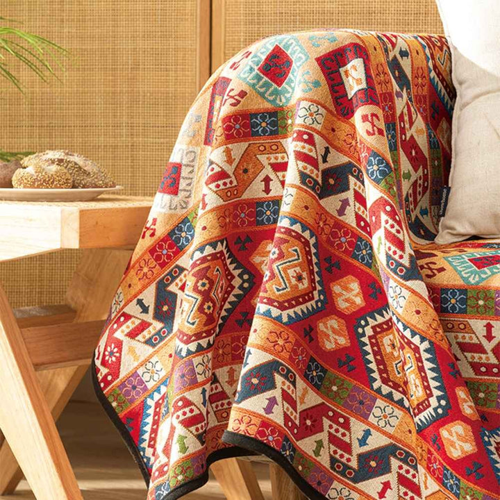 Close-up of a decorative Moroccan Jacquard throw blanket, showcasing intricate geometric woven design & texture.