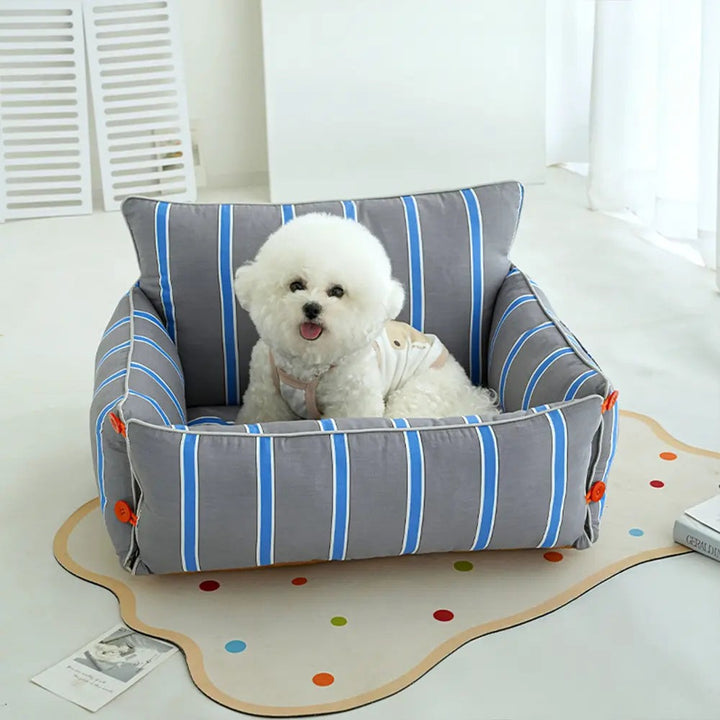Blue raised dog sofa bed with supportive bolster, washable cover & non-slip base for pet comfort. Ideal for small to medium dogs.