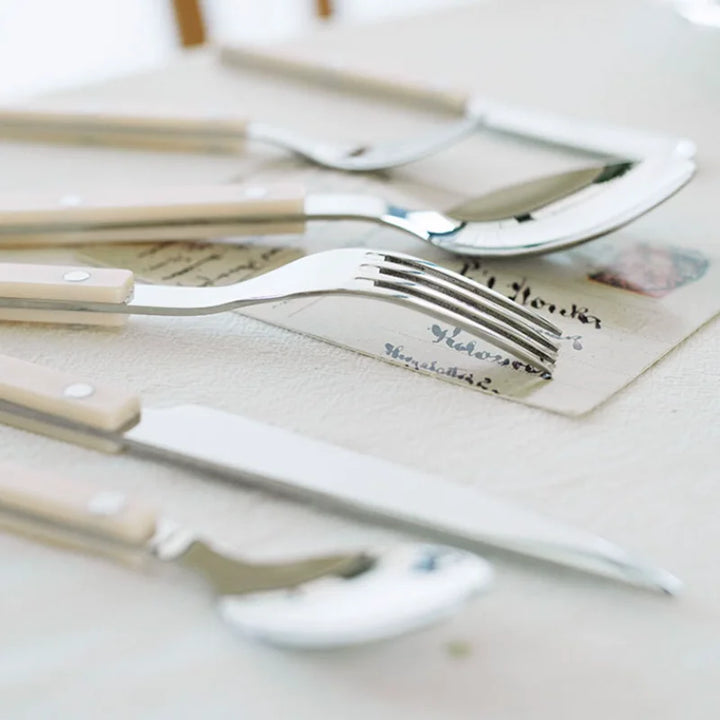 Close-up of engraved handle on a piece from the 24-piece stainless steel flatware dining set.