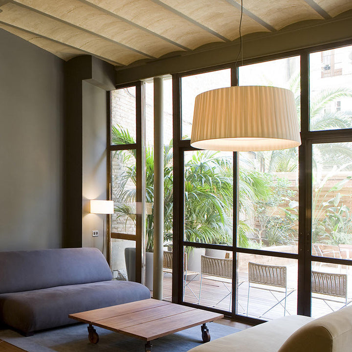 Classic brass 3-light drum pendant with luxurious silk shade for dining room elegance.