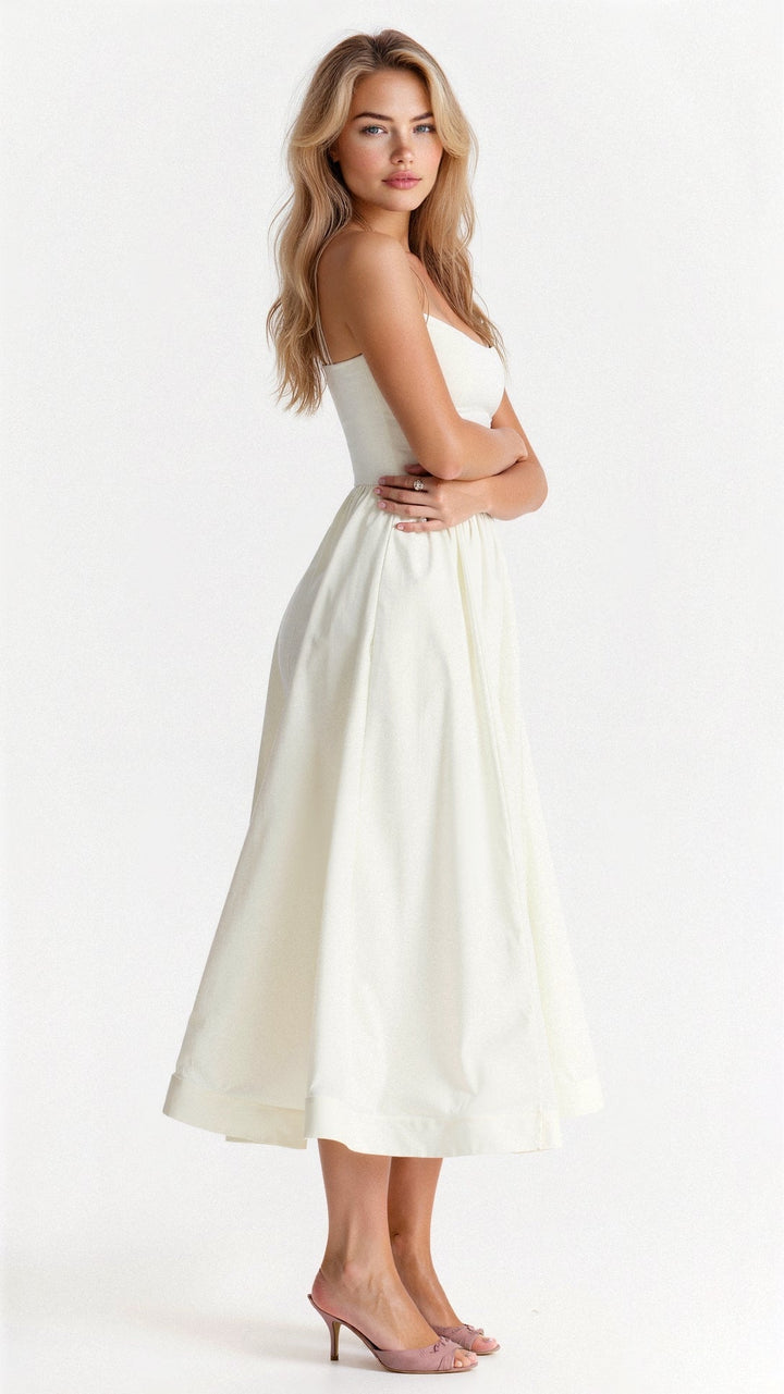 Close-up of elegant women's A-line midi dress, showcasing flowy fabric and delicate spaghetti straps.
