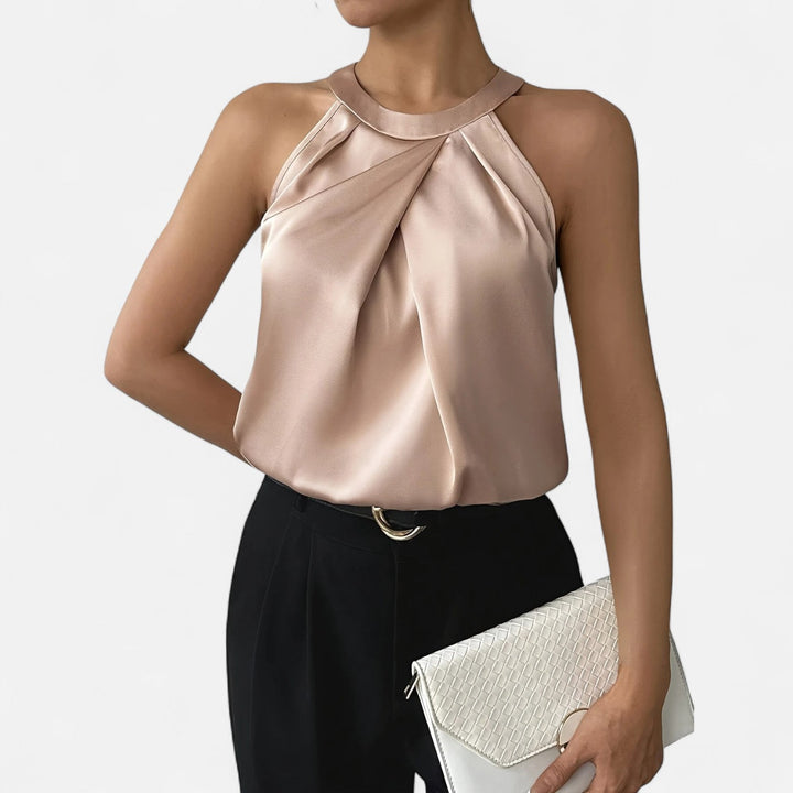 Fashionable women's beige sleeveless top made from satin, showcasing a draped and pleated front.