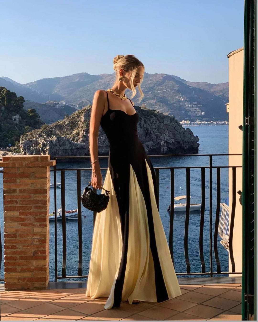 Maxi wedding guest dress featuring a sophisticated contrast and sweetheart neckline.