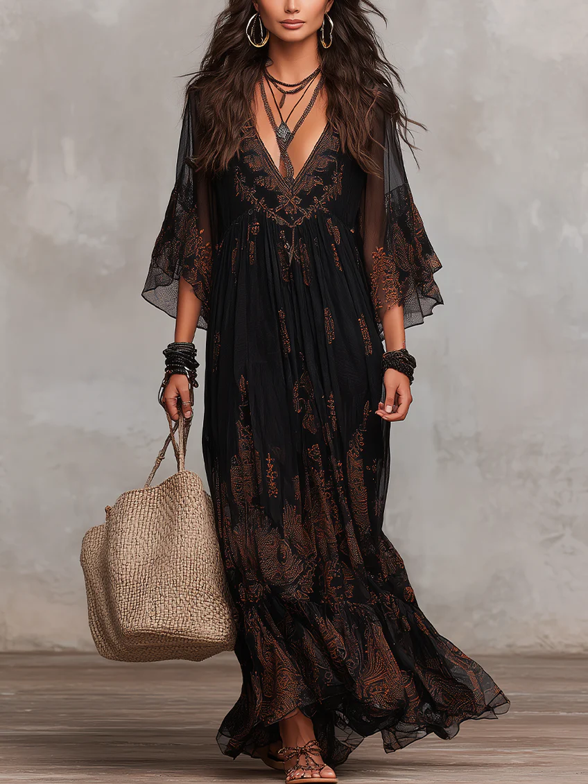 Elegant black boho maxi dress for women, featuring a flattering V-neck, flowy flutter sleeves, and a tiered skirt.