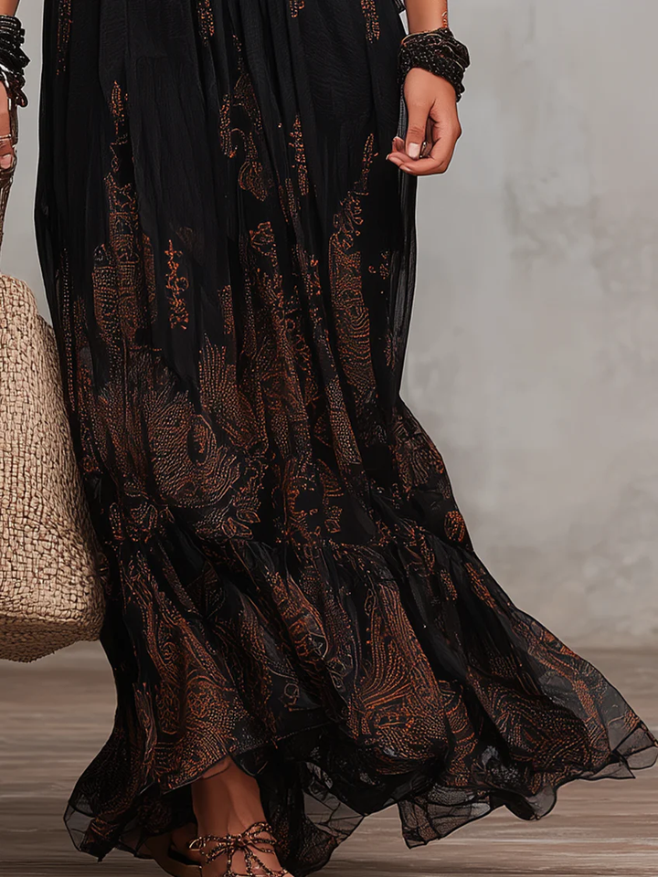 Flowy black maxi dress for women, boho style, with a comfortable V-neck, elegant flutter sleeves, and tiered design.