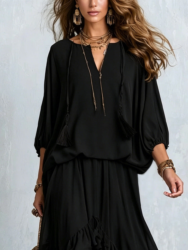 Black boho maxi skirt set for women, elegant two-piece with lantern sleeve top & tiered ruffle skirt.