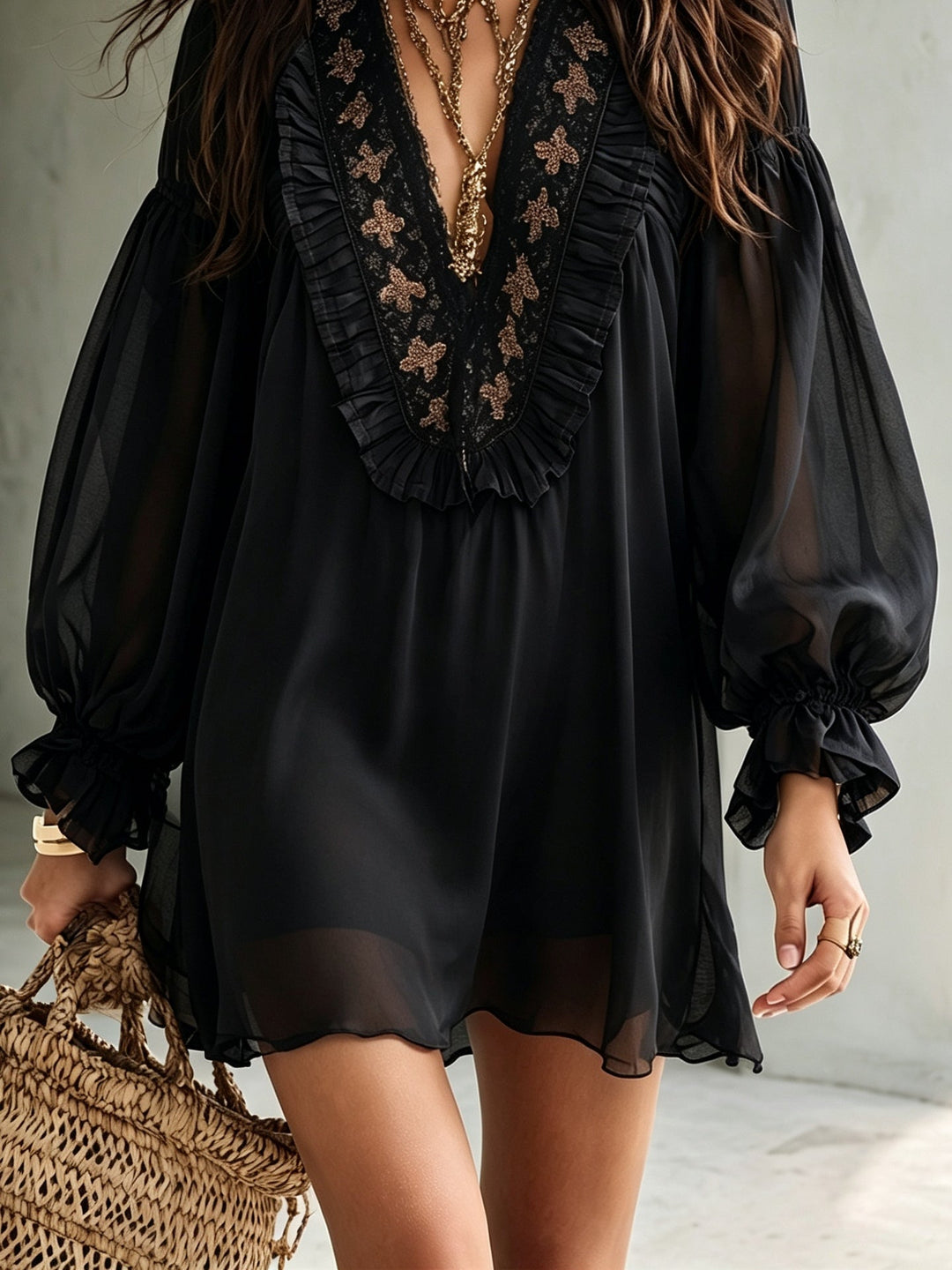 Women's elegant black mini dress with V-neck, voluminous balloon sleeves, and a flowy, comfortable swing design.