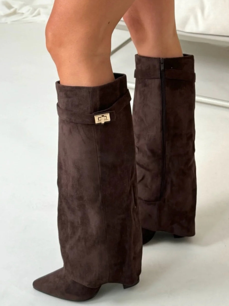 Sophisticated leather thigh-high boots for women, emphasizing the unique buckle design.