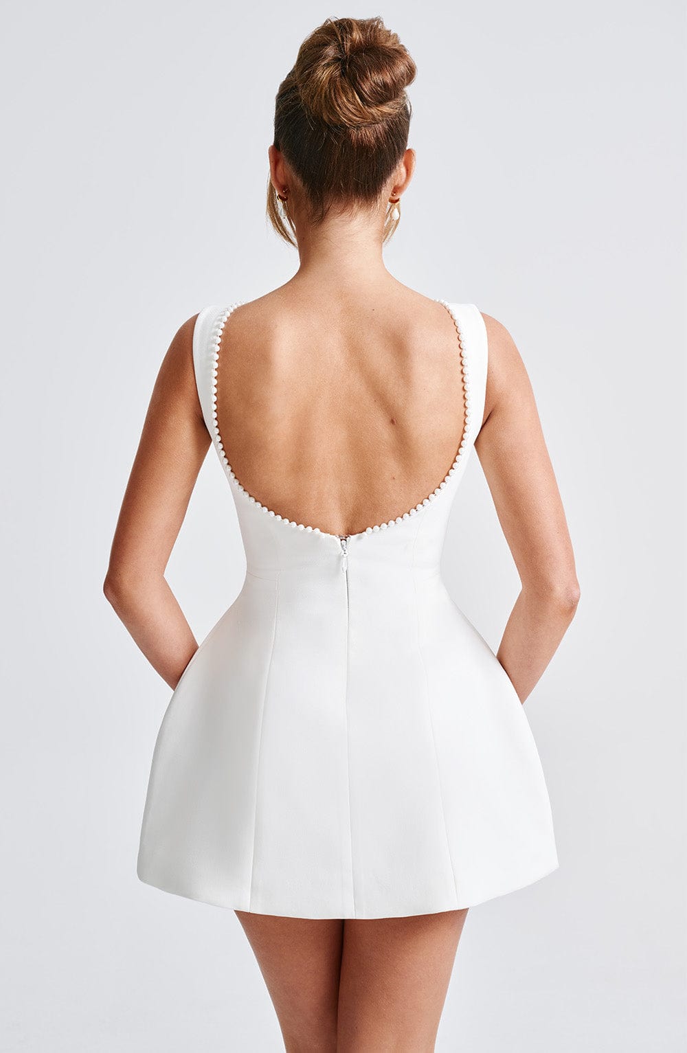 Chic women's structured mini dress in pink, an elegant choice for evening and party fashion.