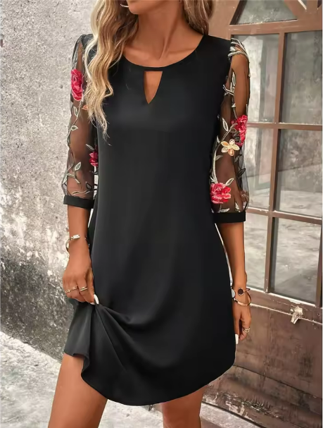Elegant black V-neck dress for women, featuring sheer long sleeves & vibrant floral print. Perfect party or occasion wear.