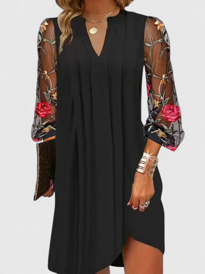 Chic women's V-neck mini dress in black, ideal for parties. Sophisticated long sleeve design for elegant evenings.