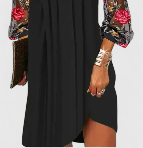 Sophisticated black V-neck mini dress for women. Elegant long sleeve cocktail party dress with chic style.