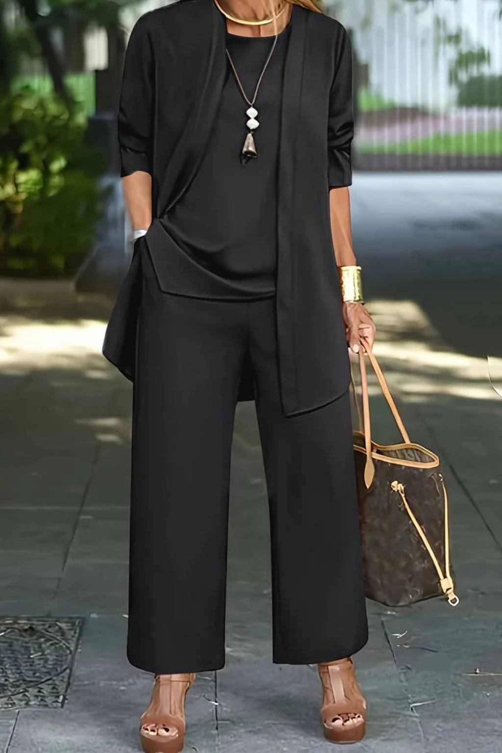 Front view of a woman wearing a chic grey formal 3-piece suit, perfect for business professional attire.