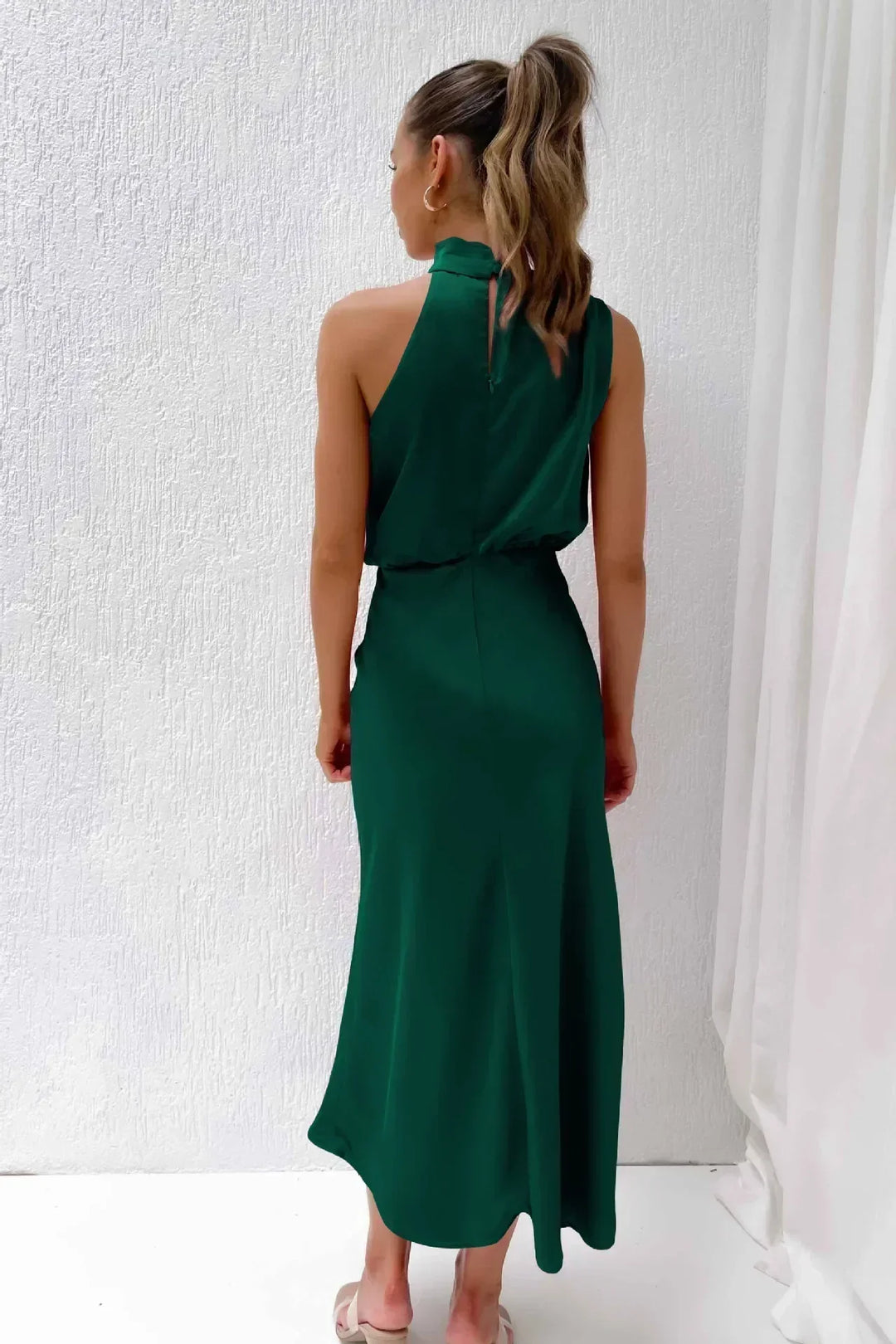 Women's stunning halter evening dress in a royal blue, featuring a chic open back design.