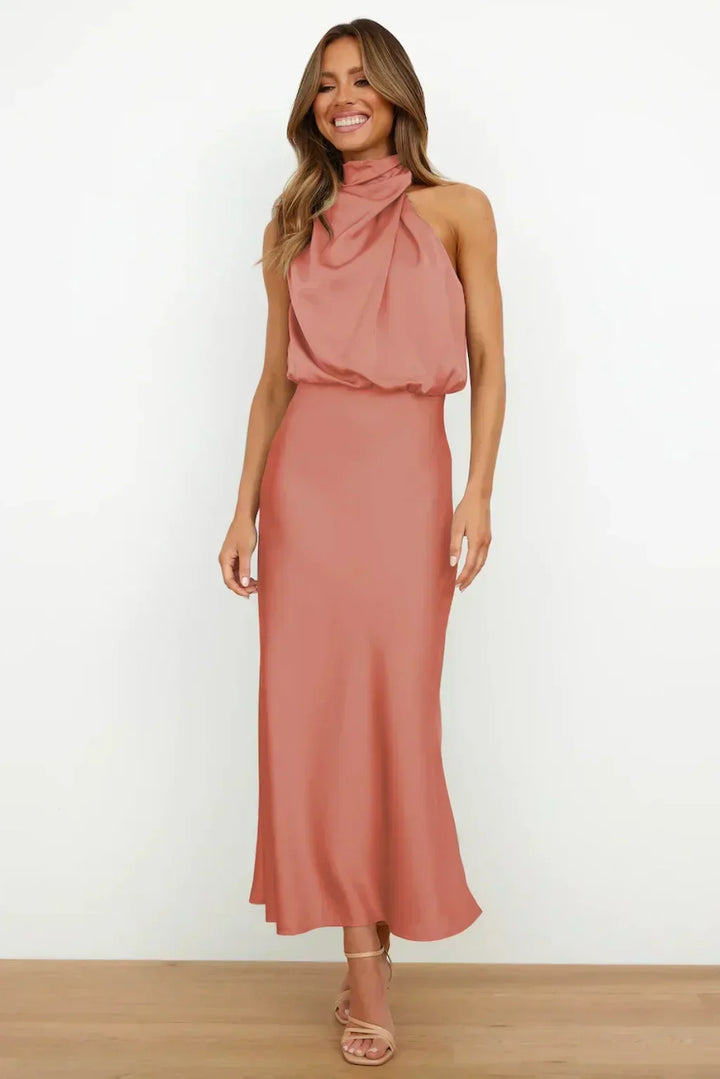 Luxurious women's blue halter formal dress, open back design, perfect for a sophisticated wedding guest.