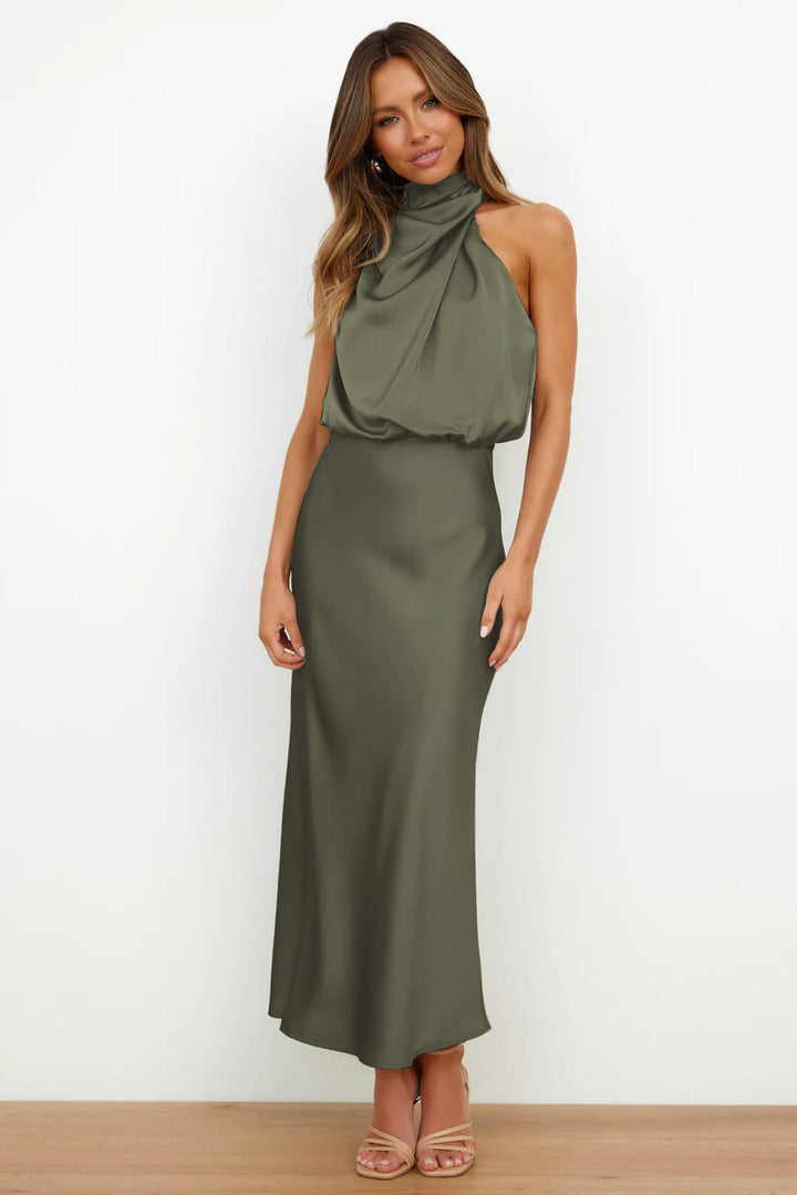 Women's elegant halter gala dress with a dramatic open back & flowing floor-length skirt.