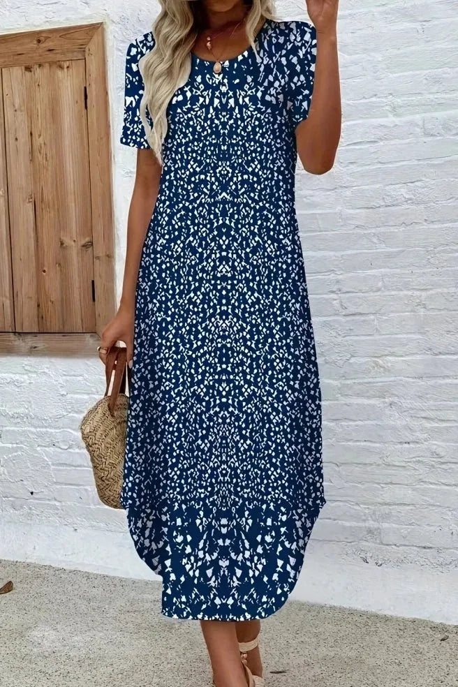 Full-length women's summer floral maxi dress, featuring an elegant design and flowing fabric.