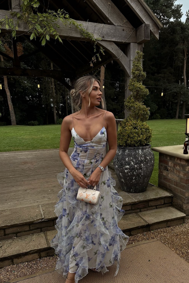 Sophisticated floral maxi wedding guest dress, V-neck corset top, and flowing ruffles for a refined look.