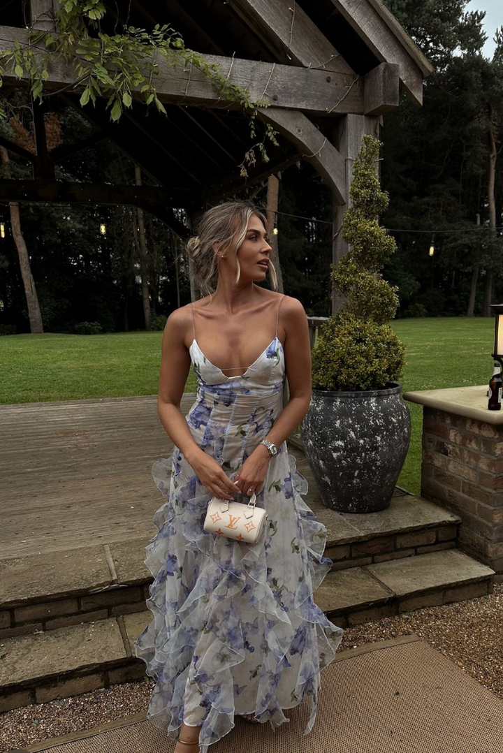 Sophisticated floral maxi wedding guest dress, V-neck corset top, and flowing ruffles for a refined look.