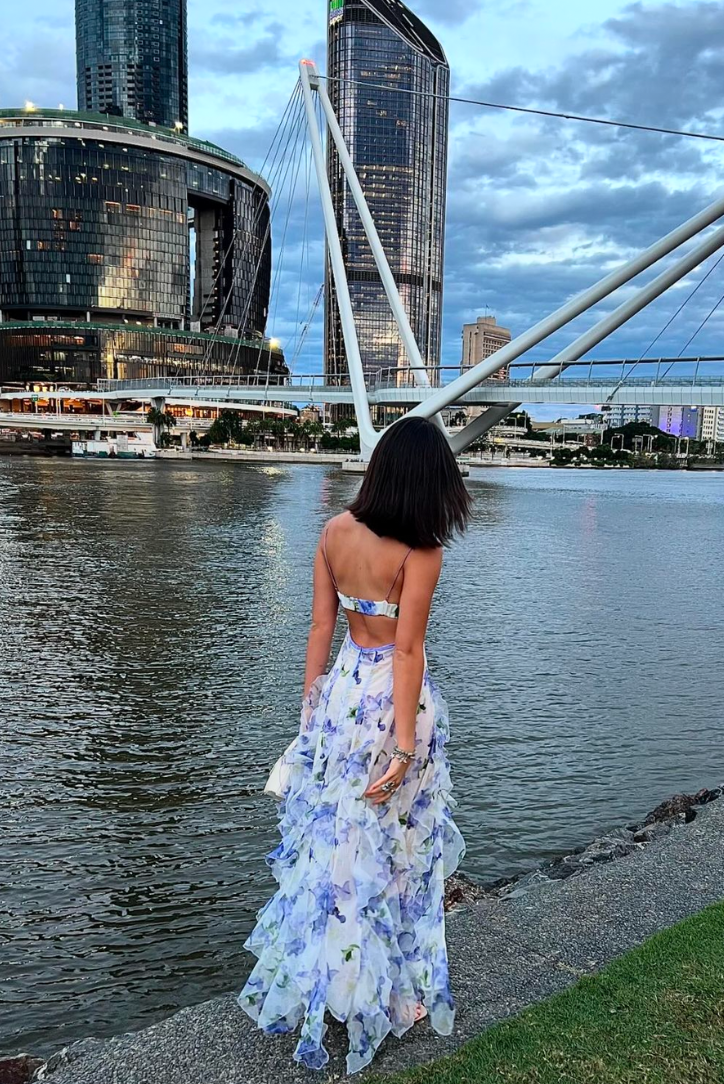 Vibrant floral print maxi wedding guest dress with a chic corset detail and elegant ruffle skirt.