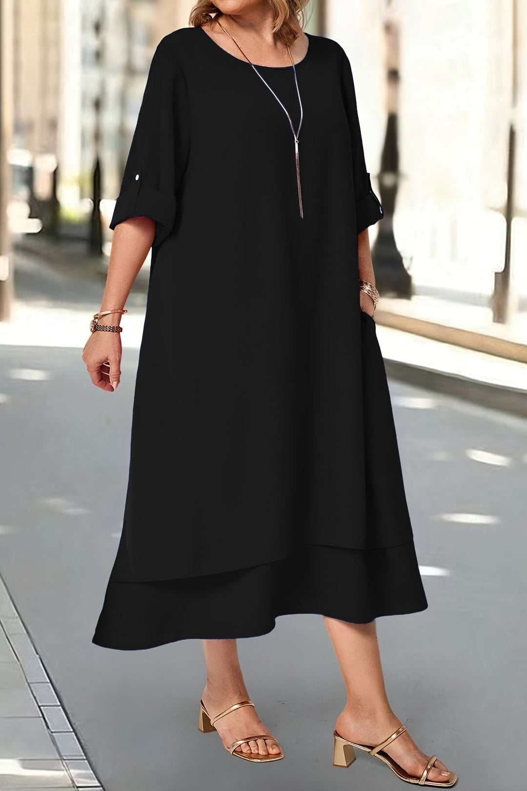 Detail shot of a women's elegant formal dress, featuring a flowing silhouette, graceful movement & comfortable design.