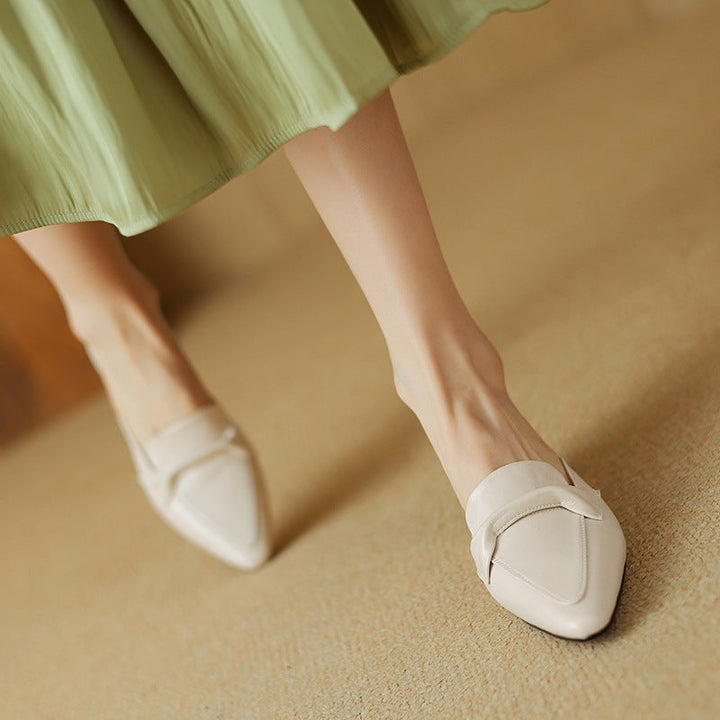 Back view of black leather bow mules for women, highlighting their chic, comfortable design