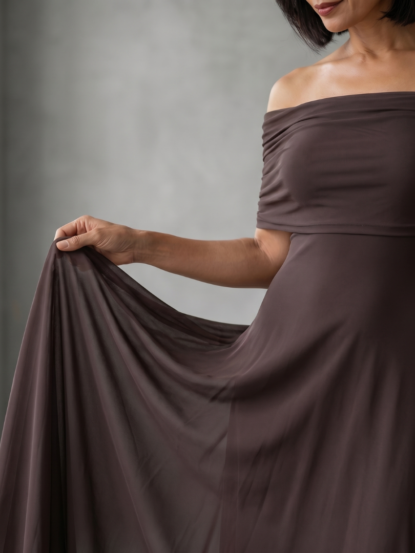 Green off-shoulder midi dress with an elegant draped bodice, a stylish choice for formal evening wear.