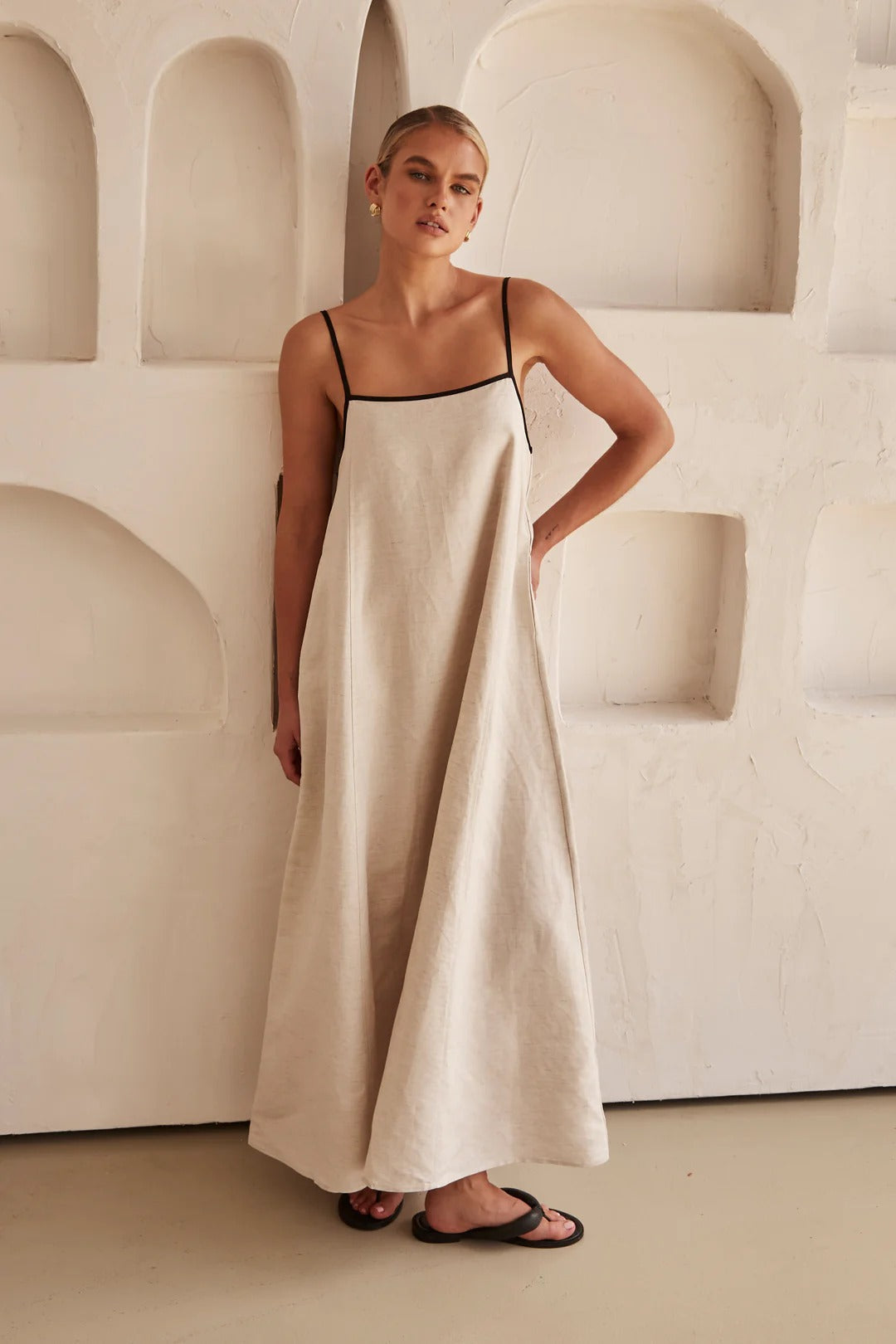 Women's oversized A-line maxi dress with spaghetti straps and chic contrast trim. Ideal for resort wear.