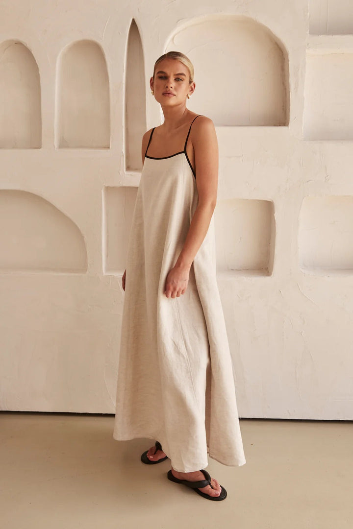 Elegant cream maxi dress with square neck and contrast trim. A-line, oversized fit, perfect for resort wear.