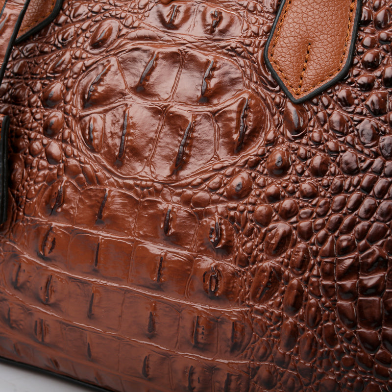 Detailed shot of the faux leather croc-embossed women's handbag, emphasizing its quality