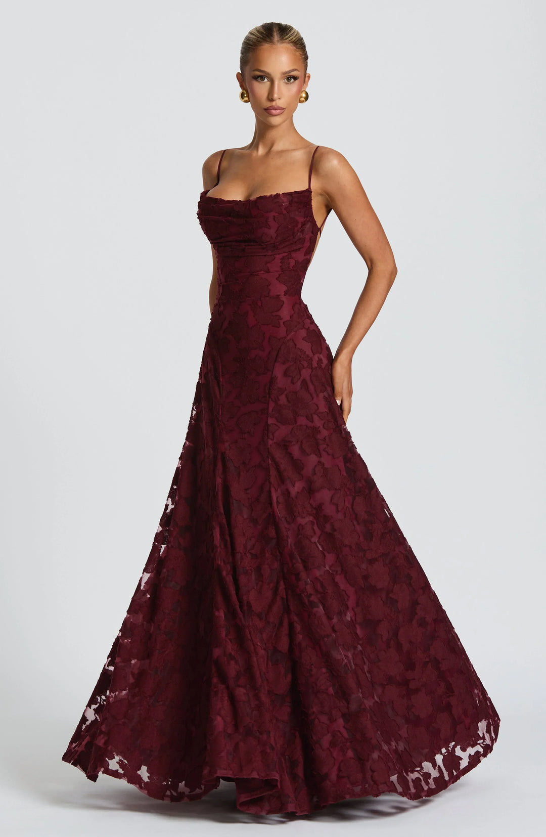 Sophisticated women's maxi dress featuring an elegant floral textured pattern, ideal for evening wear & guests.