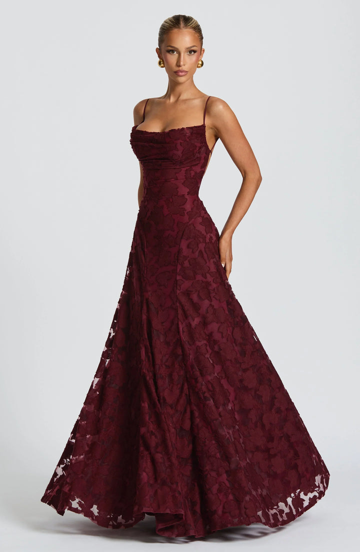 Sophisticated women's maxi dress featuring an elegant floral textured pattern, ideal for evening wear & guests.