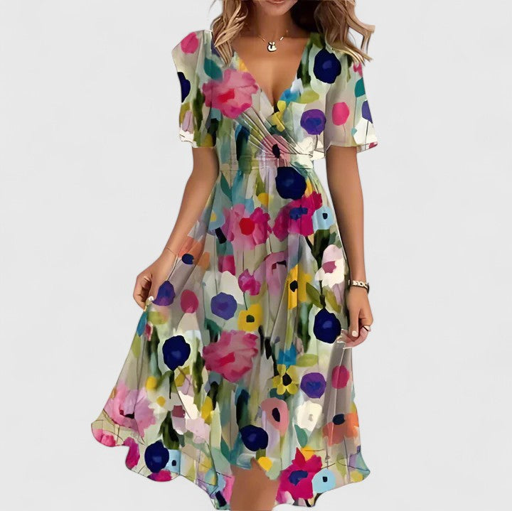 Close-up of the elegant floral fabric on a women's plunge V-neck midi dress with flutter sleeves.