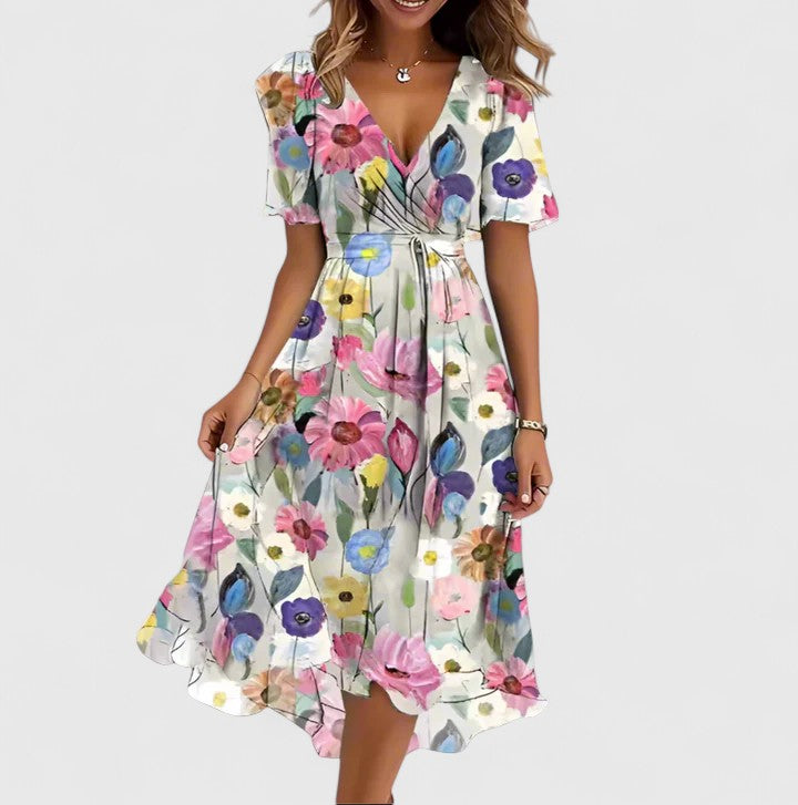 High-low hem detail of an elegant floral midi dress for women, plunge V-neck & flutter sleeves.