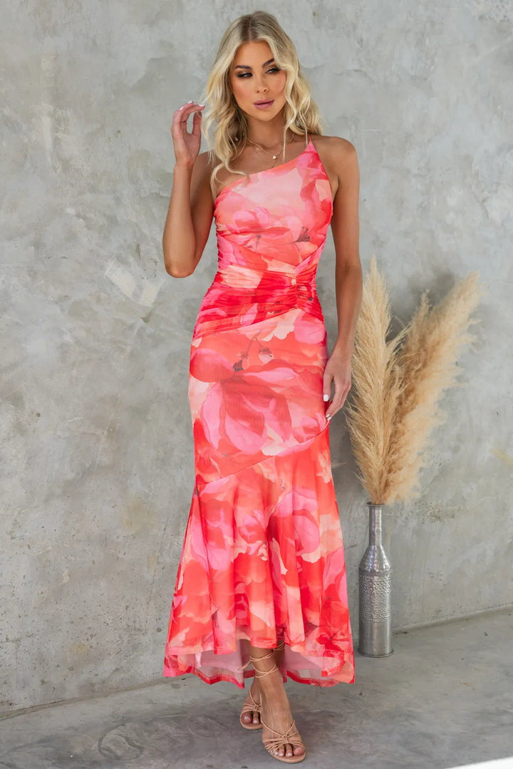 Flowy floral one-shoulder maxi dress for wedding guests, featuring a flattering ruched bodice and elegant drape.
