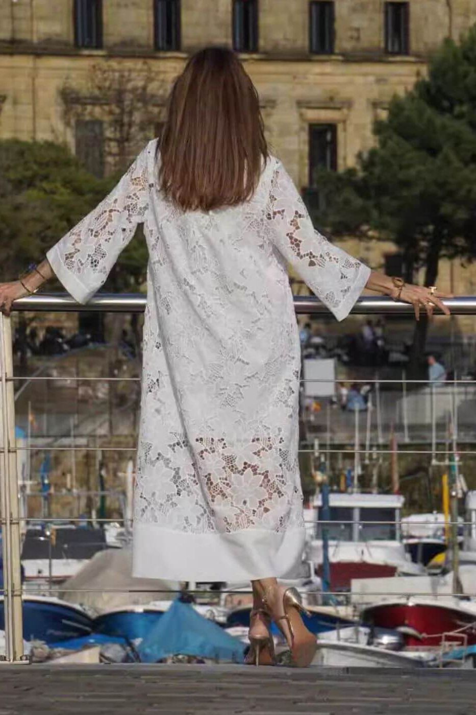 Women's timeless white maxi dress with elegant flowing fabric, suitable for formal occasions, summer parties, or resort wear.