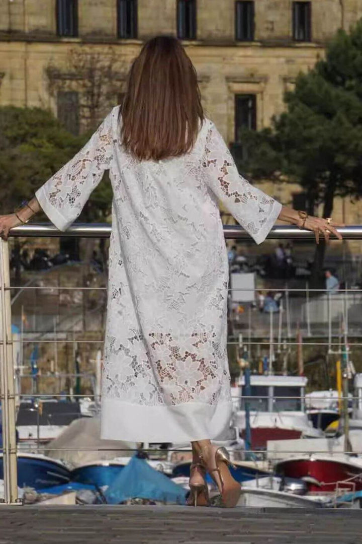 Women's timeless white maxi dress with elegant flowing fabric, suitable for formal occasions, summer parties, or resort wear.