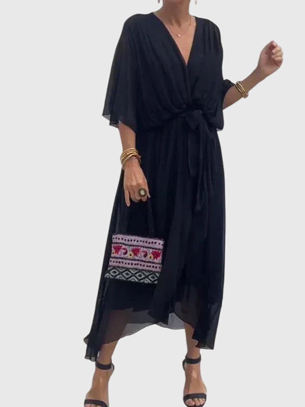 Women's V-neck midi dress with a flowing silhouette, ideal for stylish summer occasions.