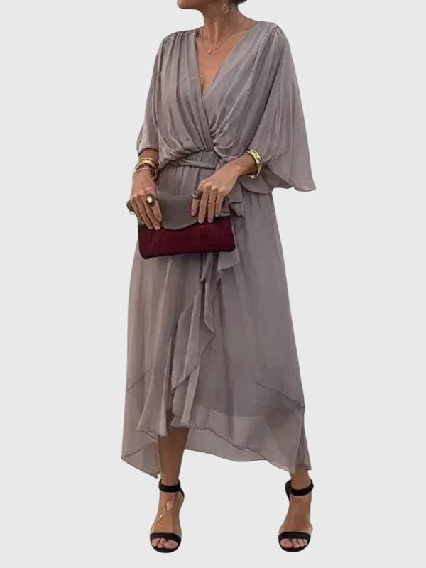 Chic women's flowy V-neck dress, a midi length summer essential for elegant fashion.