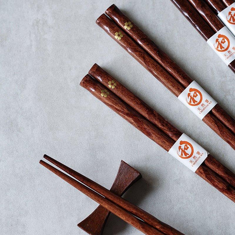 Handcrafted wooden chopsticks with intricate golden cherry blossom design. Japanese tableware gift set.