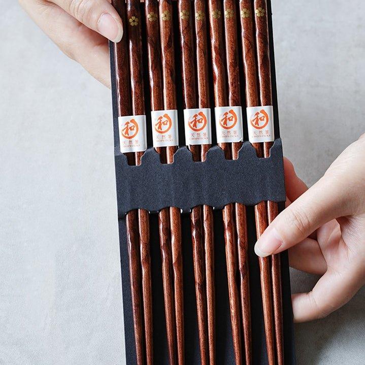 Golden cherry blossom design on elegant wooden chopsticks. Perfect for upscale kitchenware & dining.
