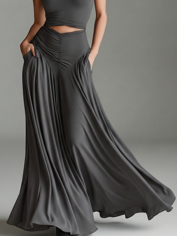 Stylish gray maxi dress with halter neckline, elegant cutout waist, and flowing ruched skirt. Women's formal wear.