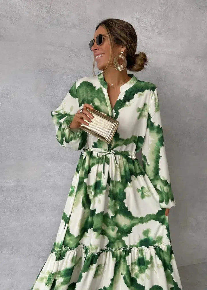 Elegant green maxi dress for women, featuring puff sleeves, V-neck, and a flowy tiered skirt for formal events.