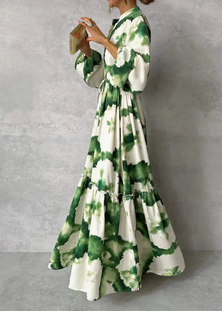 Women's formal green evening gown with elegant puff sleeves, V-neck, and a stylish tiered maxi skirt design.