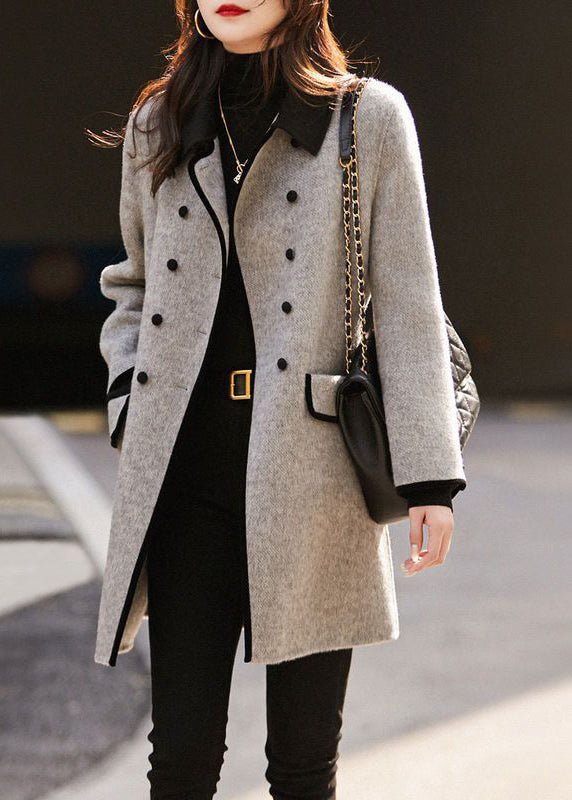Elegant grey women's tailored coat, perfect for sophisticated winter fashion. Classic structured outerwear.