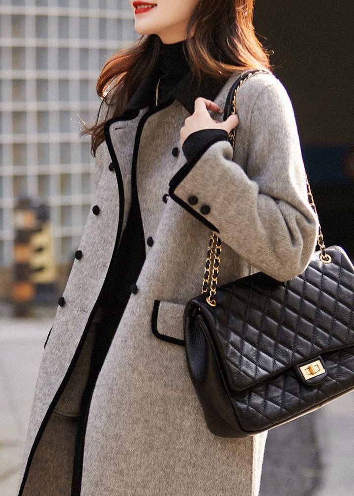 Sophisticated grey tailored women's coat with structured design, ideal for elegant winter fashion & fall wardrobe.